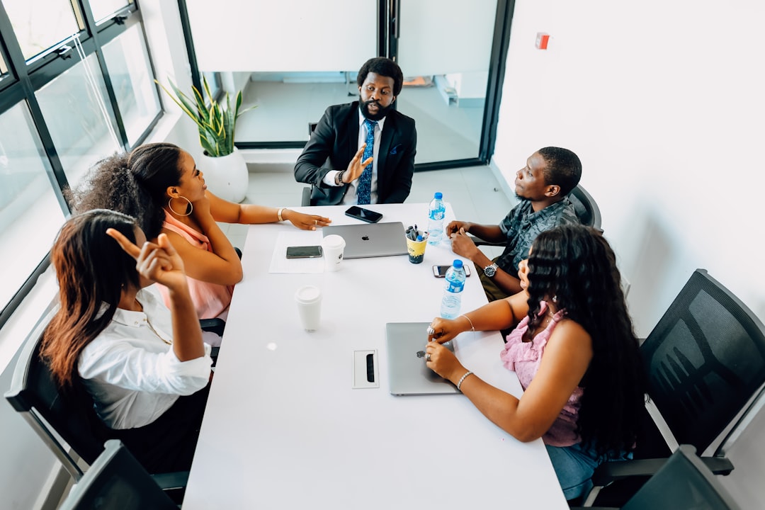 A team and their manager meeting in a conference room