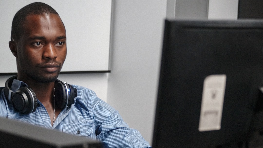 Officer reviewing records on a computer screen in an office
