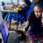 Entrepreneur working on a laptop, building a custom software solution