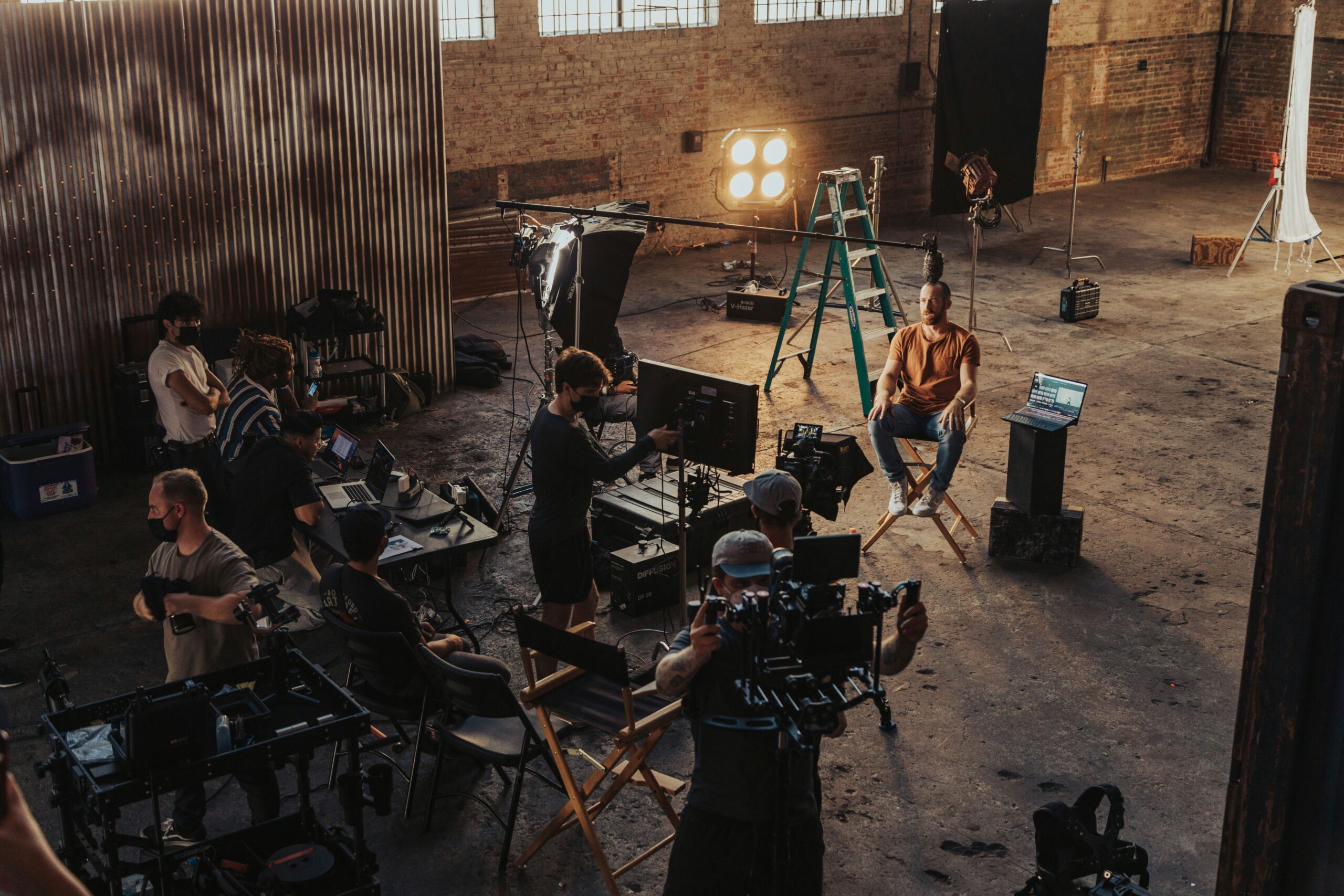 A small production crew standing around a camera set up on location